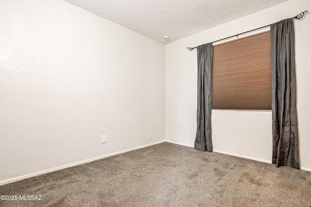 empty room with carpet floors and baseboards