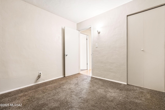 unfurnished bedroom with carpet floors and a closet