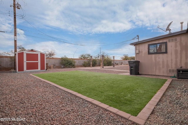 view of yard featuring a storage shed, a fenced backyard, an outbuilding, cooling unit, and a patio area