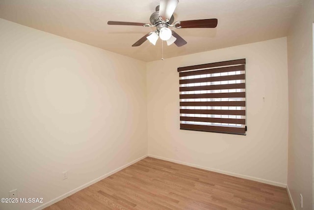 unfurnished room featuring ceiling fan, baseboards, and wood finished floors