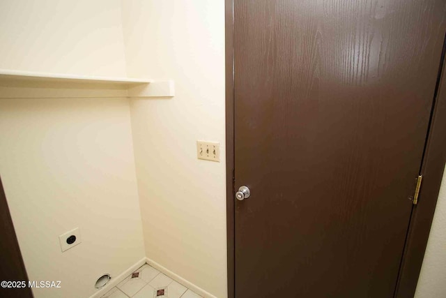 washroom featuring tile patterned flooring, laundry area, hookup for an electric dryer, and baseboards