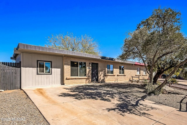 ranch-style house with brick siding and fence