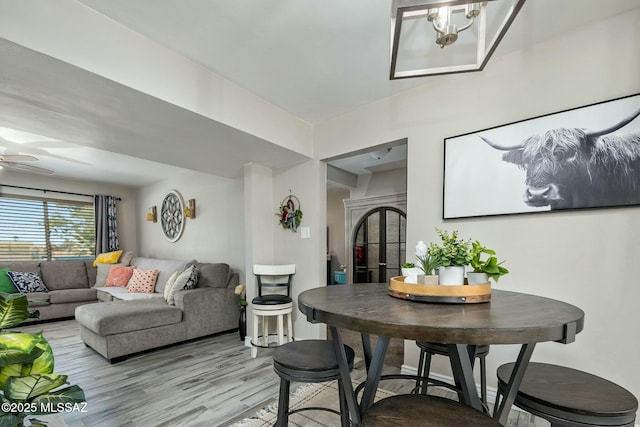 dining space featuring ceiling fan and light wood finished floors