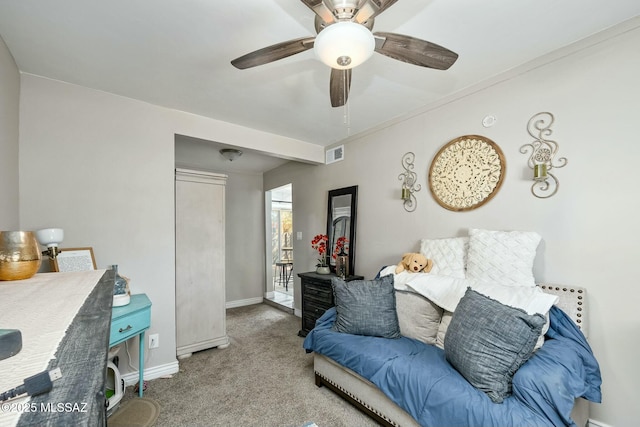 carpeted living area featuring a ceiling fan, visible vents, and baseboards