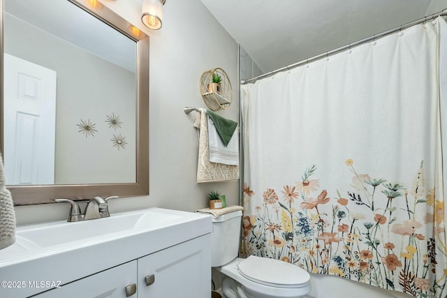 full bath featuring toilet, a shower with shower curtain, and vanity