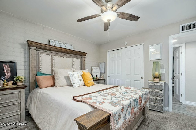 bedroom featuring carpet floors, a closet, visible vents, ceiling fan, and baseboards