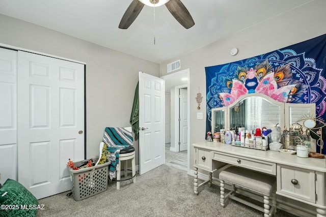 interior space featuring carpet floors, visible vents, and a ceiling fan