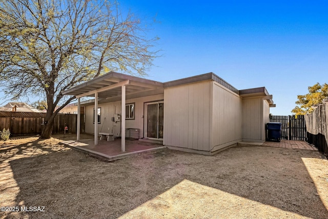 rear view of property featuring a patio area and a fenced backyard