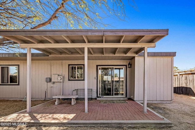 entrance to property featuring fence