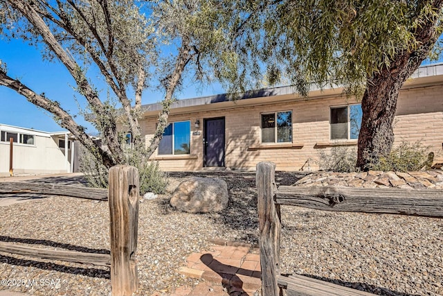 single story home featuring brick siding