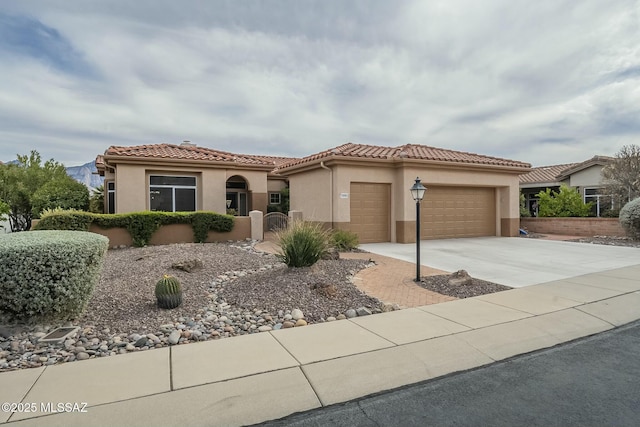 2090 E Buster Mountain Dr, Oro Valley, AZ 85755 - mediterranean / spanish-style home featuring a garage, stucco siding, a tiled roof, and driveway
