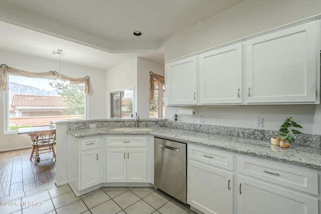 kitchen with white cabinets, dishwasher, a peninsula, hanging light fixtures, and a sink