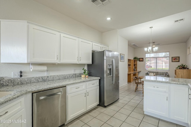 kitchen with stainless steel appliances, white cabinets, visible vents, and a chandelier