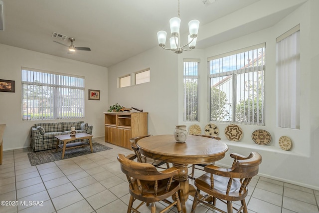 dining area featuring a wealth of natural light, visible vents, baseboards, and light tile patterned floors