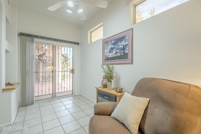 entryway featuring ceiling fan, baseboards, and light tile patterned floors