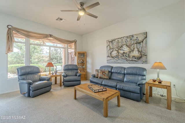 living area featuring visible vents, ceiling fan, and carpet flooring