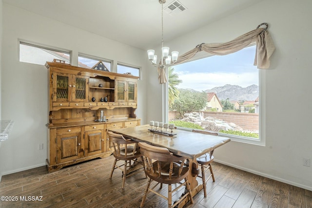 dining room with baseboards, dark wood-style flooring, visible vents, and a notable chandelier