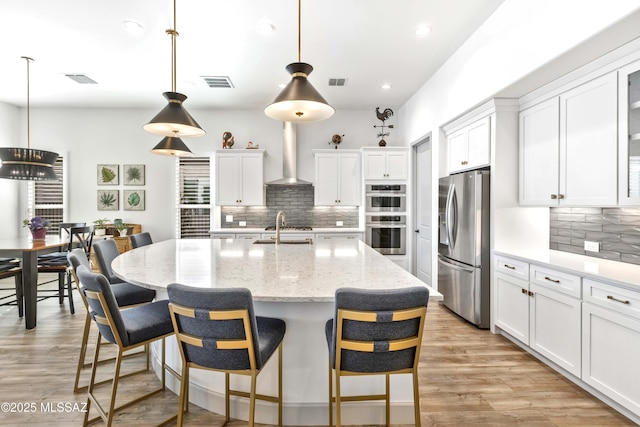 30755 S Chestnut Way, Oracle, AZ 85623 - kitchen with stainless steel appliances, tasteful backsplash, wall chimney exhaust hood, a sink, and recessed lighting