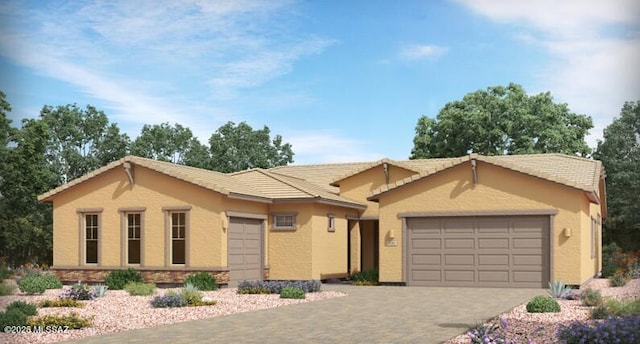 single story home featuring a garage, driveway, a tiled roof, and stucco siding