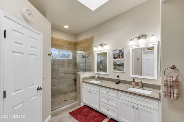 full bathroom with a skylight, a stall shower, and a sink