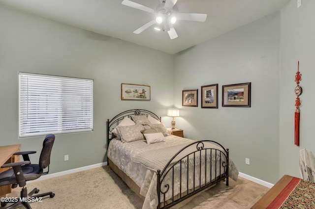 carpeted bedroom featuring baseboards and ceiling fan