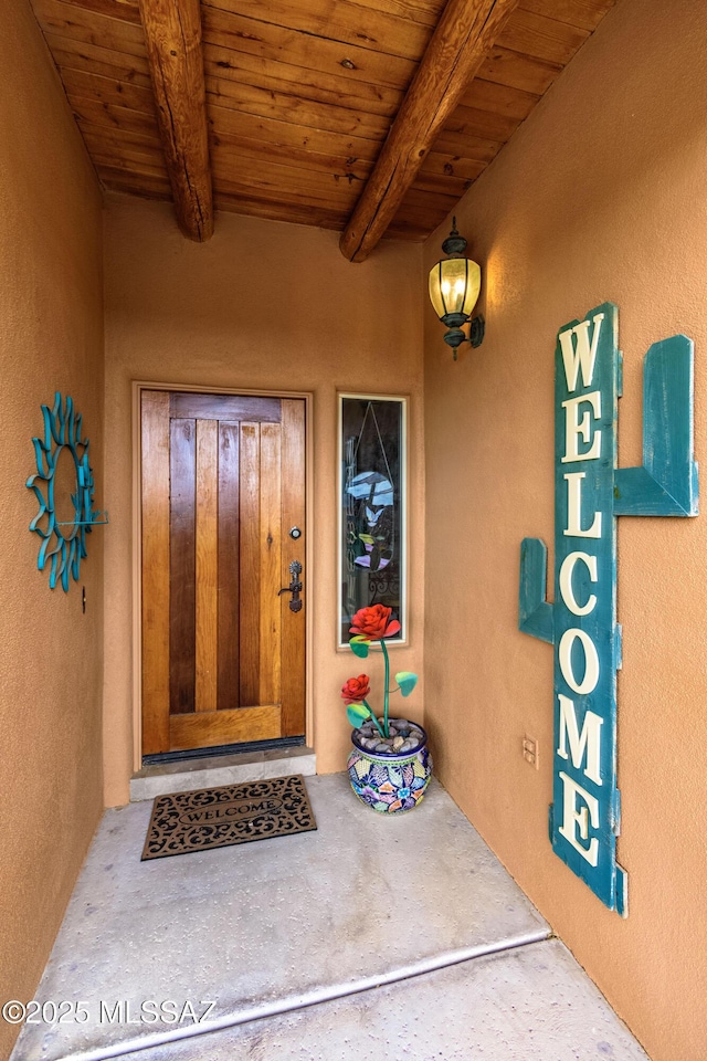 entrance to property featuring stucco siding