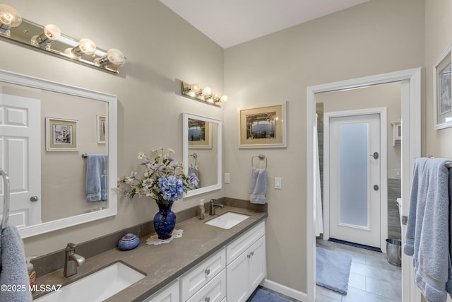 full bathroom with tile patterned flooring, double vanity, and a sink