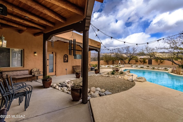 view of swimming pool with a fenced in pool and a patio area