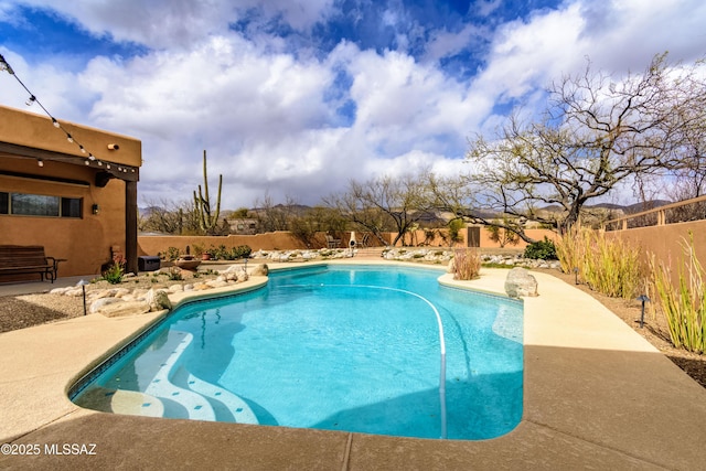 view of pool featuring a fenced in pool, fence, and a patio area