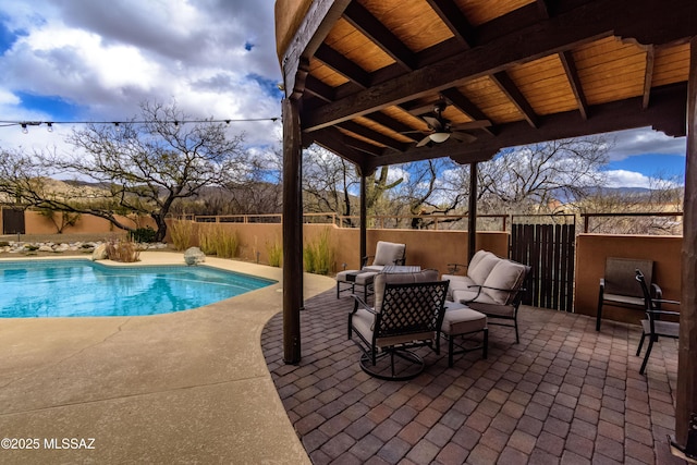 view of swimming pool featuring a patio area, an outdoor living space, fence, and ceiling fan