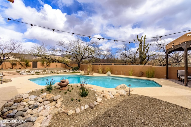 view of swimming pool featuring a patio area, a fenced backyard, and a fenced in pool