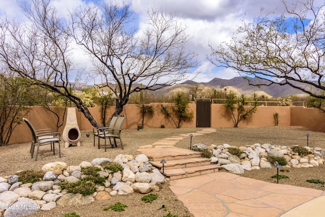 view of yard with a mountain view and a fenced backyard