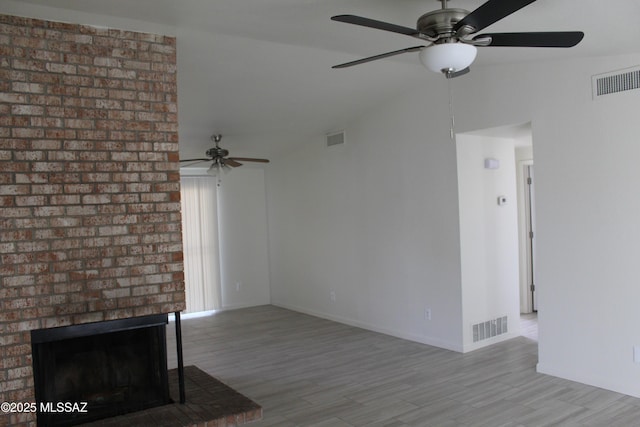 unfurnished living room featuring visible vents, lofted ceiling, and ceiling fan