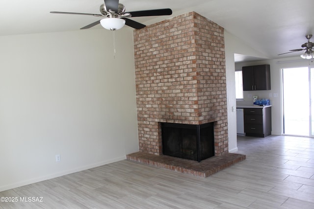 unfurnished living room with a brick fireplace, light wood-style floors, a ceiling fan, and vaulted ceiling