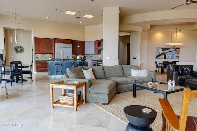 living area featuring recessed lighting and a towering ceiling