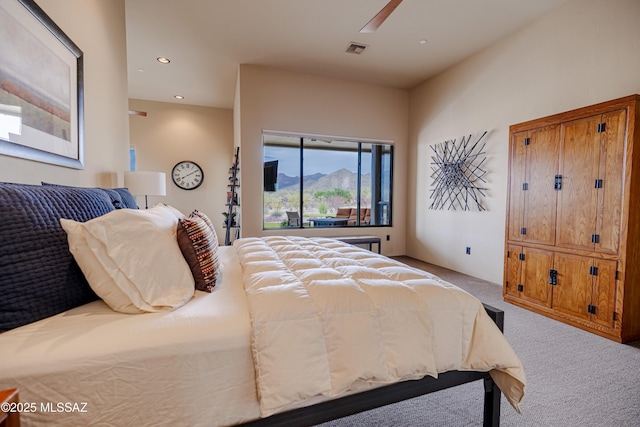 bedroom featuring visible vents, ceiling fan, light colored carpet, recessed lighting, and a mountain view