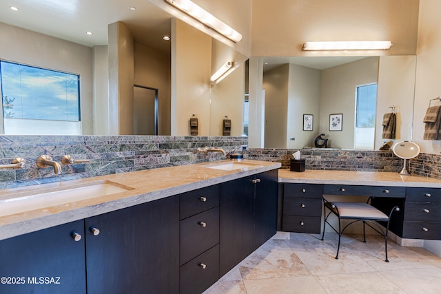 bathroom featuring decorative backsplash, double vanity, recessed lighting, and a sink