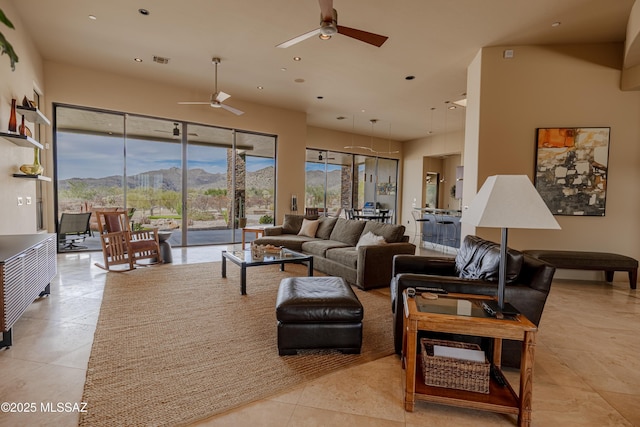 living room with recessed lighting, visible vents, a mountain view, and light tile patterned floors