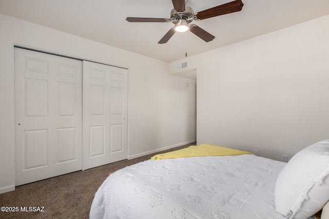 bedroom featuring a closet, carpet flooring, visible vents, and baseboards