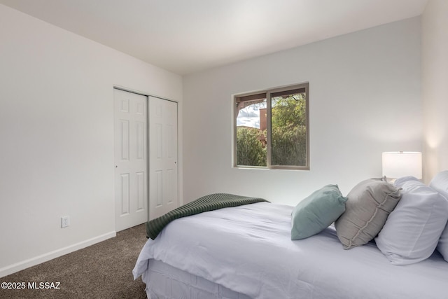 carpeted bedroom featuring a closet and baseboards