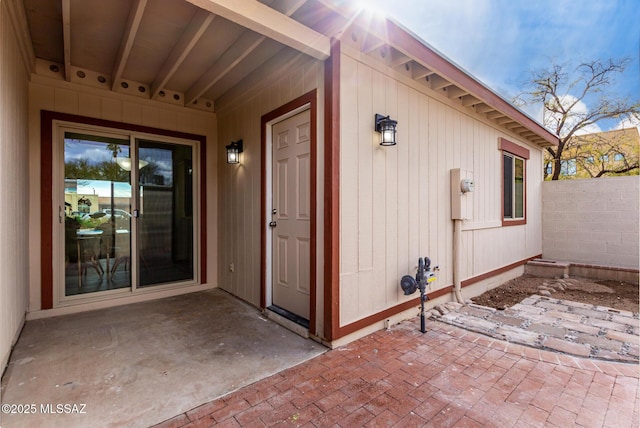 property entrance featuring a patio and fence