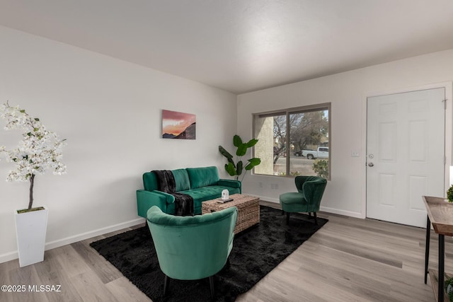 living area with light wood finished floors and baseboards