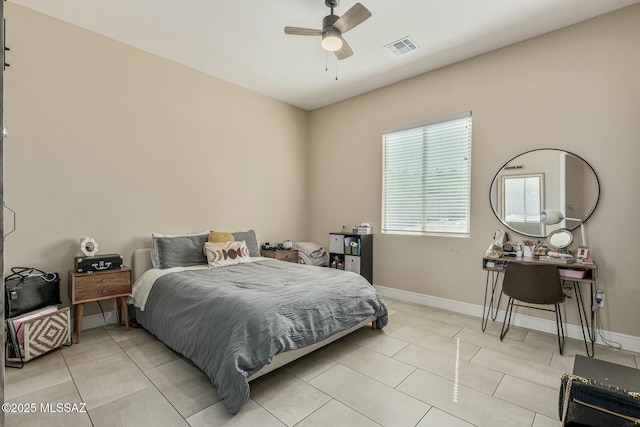 bedroom with a ceiling fan, light tile patterned flooring, visible vents, and baseboards