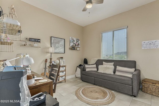 tiled living room with baseboards and a ceiling fan