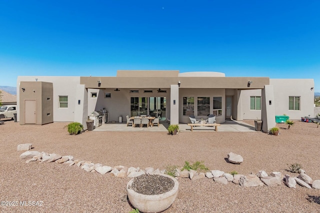 back of house featuring a patio and stucco siding