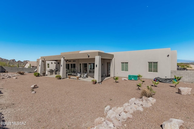 back of house featuring a patio area, a fenced backyard, and stucco siding