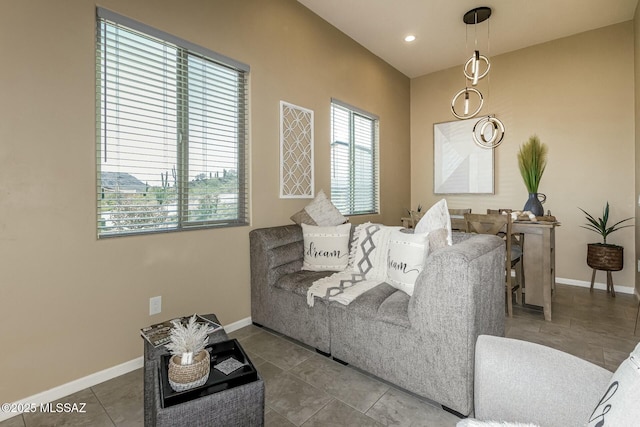 living room with a wealth of natural light, baseboards, and tile patterned floors