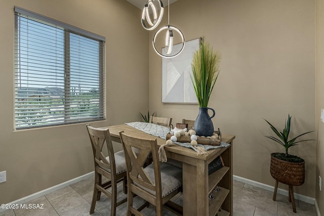 dining area with light tile patterned floors and baseboards