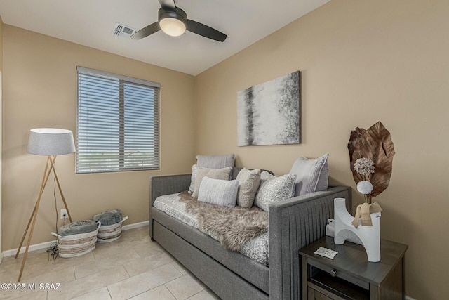 living room featuring baseboards, visible vents, a ceiling fan, and light tile patterned flooring