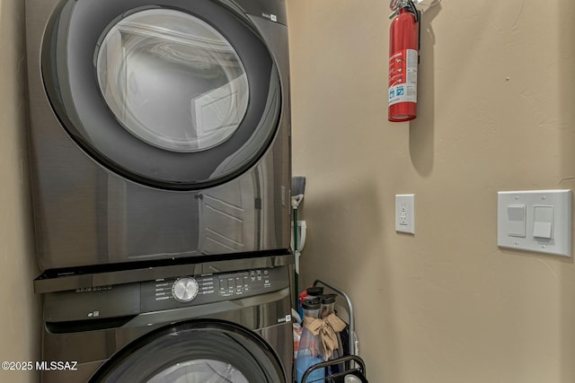 washroom with stacked washer / dryer and laundry area